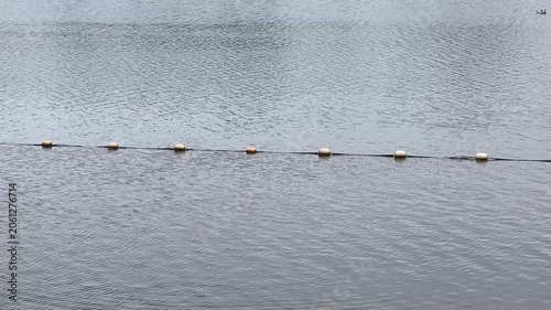 Floating buoys marking a line across calm water