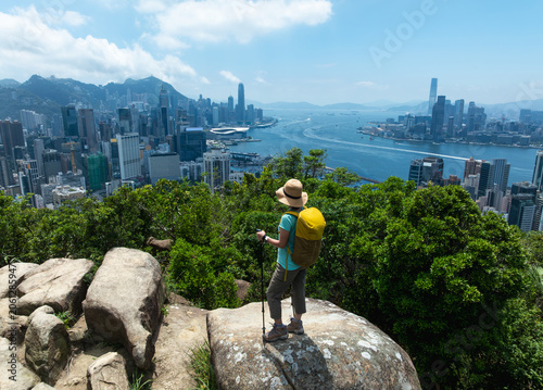 Woman hiking on mountain top in Hong Kong
