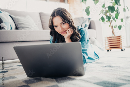 Bild auf Leinwand Young woman working on laptop at home living room, relaxed remote work and onlin