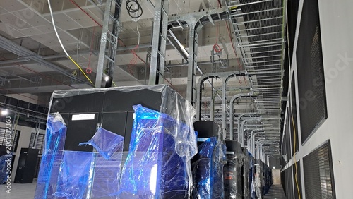 Industrial PDU cabinets and complex cable trays inside a data center under construction