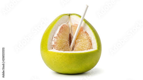 Large fresh pomelo jeruk bali fruit cut open with a drinking straw inside isolated