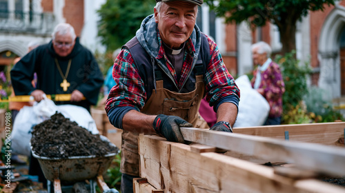 Retired carpenter builds raised wooden planting beds in a church courtyard, a parish priest assists by holding a level while elderly parishioners carry bags of soil from a wheelbarrow, the scene sho