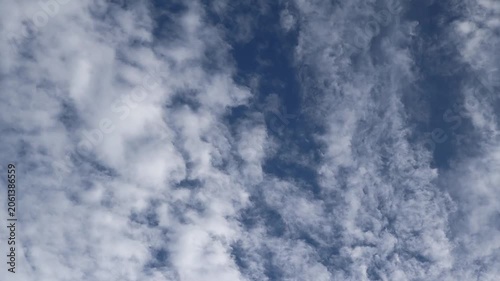 Soft clouds drift across a bright sky creating a peaceful natural backdrop.
