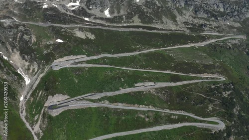 Furka Pass in Switzerland at Sunny day, Aerial View at Summer. Picturesque Curvy Road is Twisting in Alps Mountains