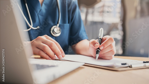 Medical doctor completing administrative healthcare records