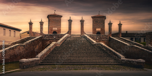 Famous Trepponti bridge at sunset in Comacchio, Emilia-Romagna, Italy