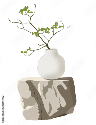 Green plant branches in a white ceramic vase on a natural stone block. Minimalist zen, wabi-sabi, and japandi home decor concept