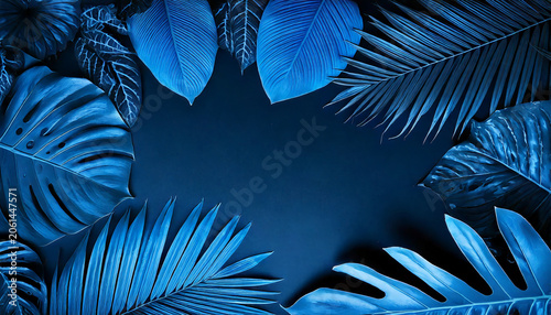 Vibrant blue tropical leaves arranged as a frame