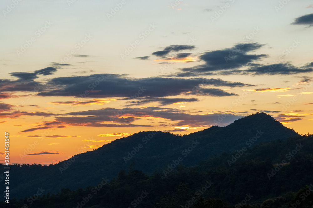 Obraz premium Blue golden sky sunrise dramatic beautiful landscape mountain. Dramatic sunset over mountain landscape. Beautiful landscape foggy hills twilight time. Dawn sky gold dusk time cloudscape with sunlight