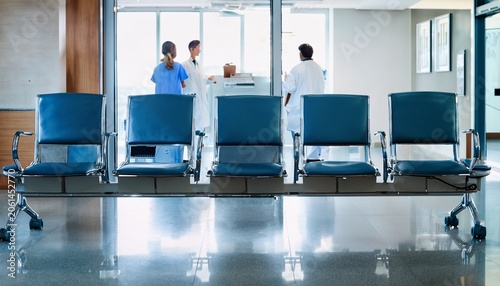 hospital waiting room chairs with doctors walking by