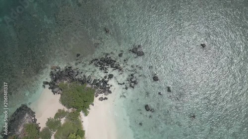 Top Down Aerial Of Volcanic Boulders White Sand And Clear Shallows
