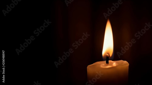 Single lit white candle flame burning brightly in dark background with melted wax dripping down side of pillar taper