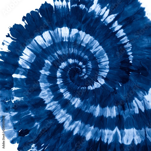A blue and white spiral tie-dye pattern on a circular fabric