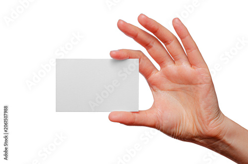 A person's hand holds a blank white business card against a solid white background.