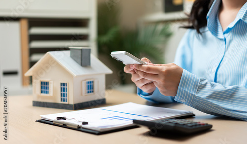 Tableau sur toile Home insurance and property management concept with smartphone technology, real estate investment planning, housing finance, mortgage services, digital property management, and homeowner solutions