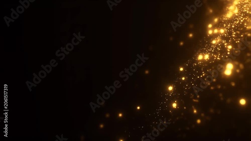 Golden bokeh particles swirl diagonally across dark background creating magical glowing light effect for holiday or celebration design projects.