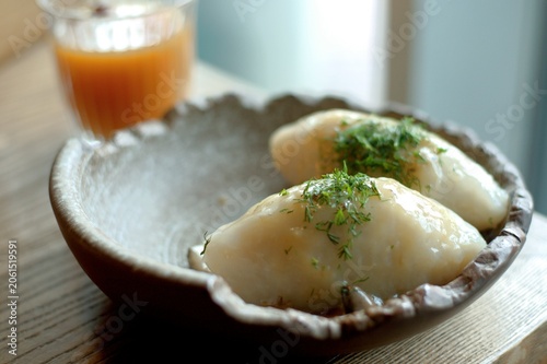 Tableau sur toile Lithuanian national dish - cepelinai or didzkukuliai with fried bacon and herbs