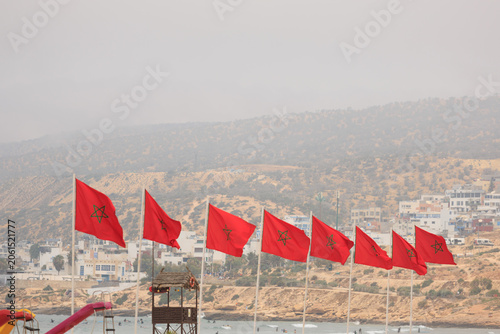 Quadro su tela a row of moroccan national flag flying in the air with mountain in the backgroun