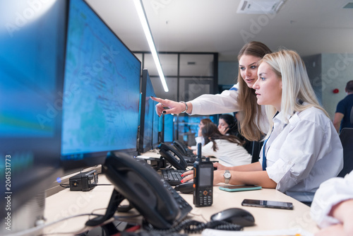 Security Team Cooperating and Reviewing Data on Screen