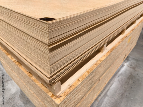 Fiberboards and Oriented Strand Boards or OSB, large stacks of construction panels stored in warehouse