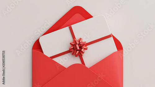 A red envelope with a white gift card and red ribbon tied in a bow on a light gray background for valentines day or christmas