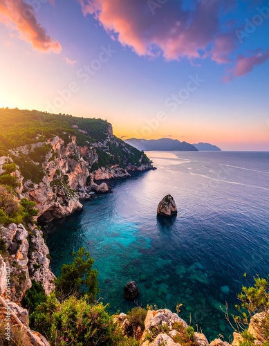 A serene coastal scene at sunset with rugged cliffs, clear turquoise water, and a solitary rock formation