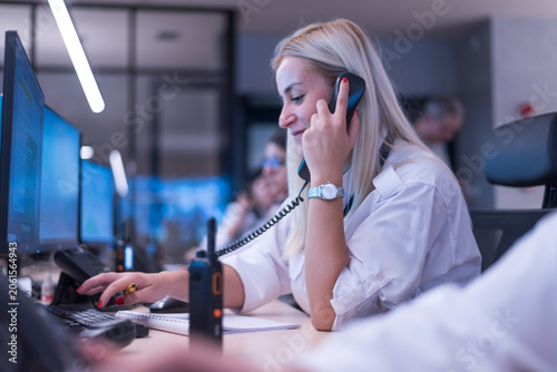 Female Operator Talking on Phone in Surveillance Control Center