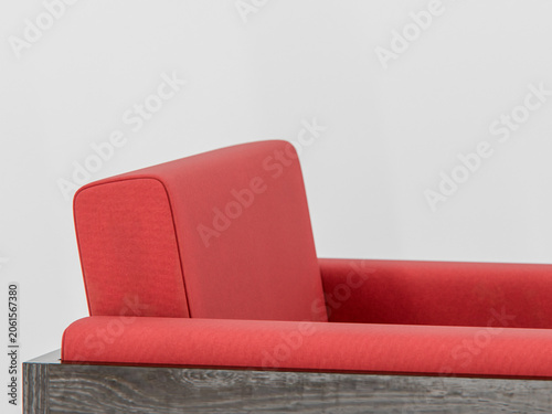 Close-up of vibrant red sofa fabric. Cushioned seat and backrest show bold color. Dark wood base contrasts with white wall. Clean lines emphasize modern aesthetic. Ideal for interior design content