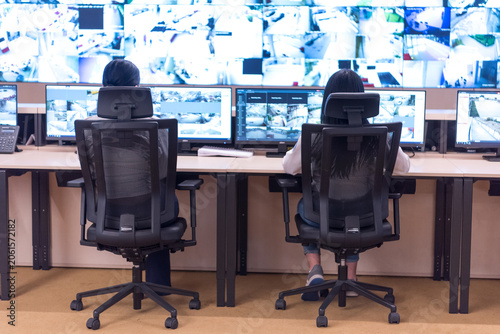 Operators Monitoring Video Wall in Security Operations Center