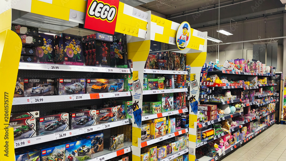 Naklejka premium Hohenlimburg, Germany - June 12, 2026: Brightly lit toy aisle with LEGO sets displayed on shelves inside Kaufland supermarket