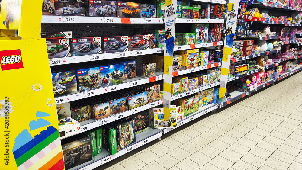 Naklejka premium Hohenlimburg, Germany - June 12, 2026: Supermarket aisle stocked with LEGO toy sets and other toys displayed on shelves inside Kaufland supermarket