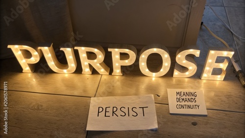 Illuminated Letters Spelling Purpose with Inspirational Words Persist Meaning Demands Continuity on Wooden Floor Background