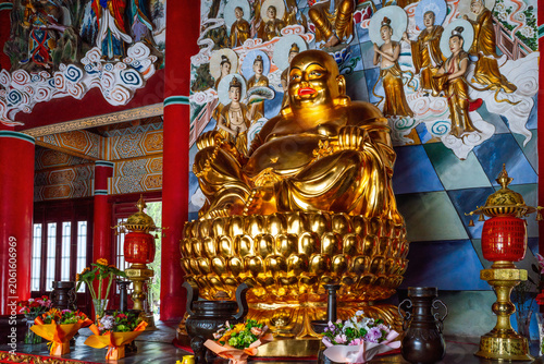 Golden Laughing Buddha Statue on Lotus Throne Inside Da Xingshan Temple Hall in Xi'an, China