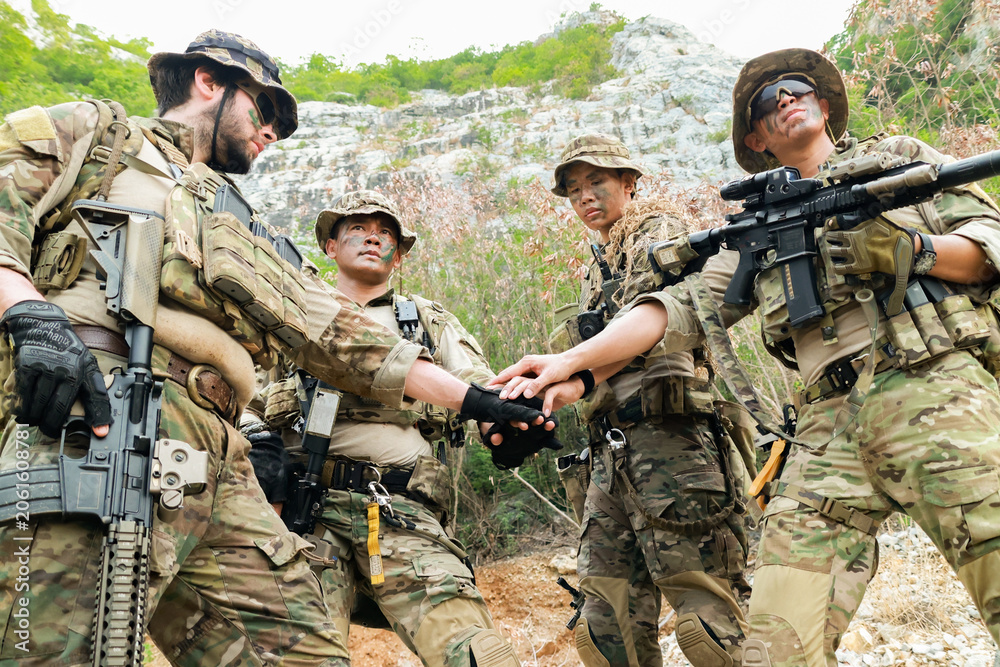Fototapeta premium Special forces units, armed with war weapons are joining forces in unity surprise attack preparing mission to assault the enemy military.