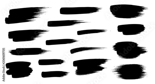 Foto Set of various black paint brush strokes and ink textures on white background