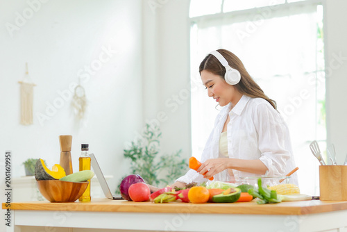 Fotografie Healthy lifestyle Asian yong women start by eating fruits rich in vitamins to nourish their skin choosing organic vegetarian vegetables and enjoying preparing healthy meals at home