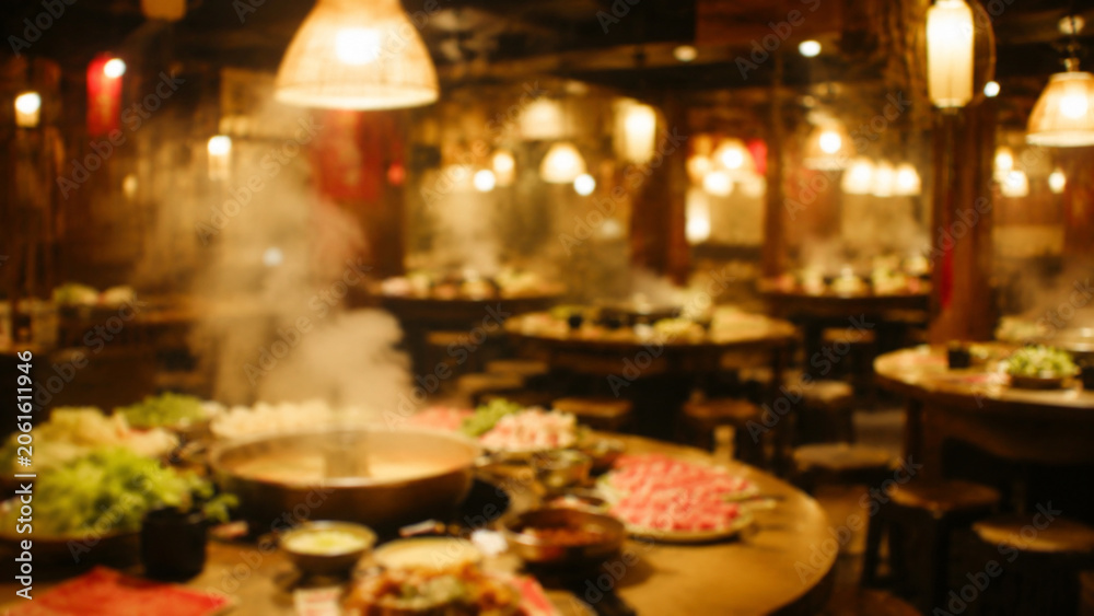 Fototapeta premium Blurred Asian Hotpot Restaurant Interior with Warm Lighting.