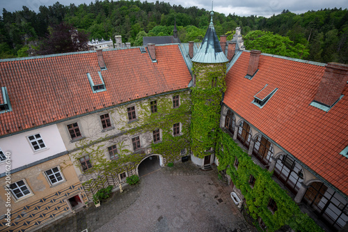 View of the courtyard and ivy-covered tower at Hruba Skala Castle in Bohemian Paradise (Cesky raj), Czech Republic, historic stone architecture surrounded by greenery nature view