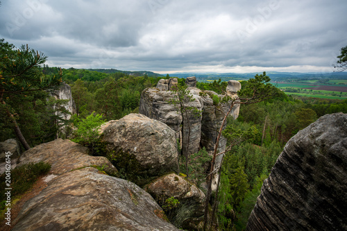 Rock city formations in Hruboskalsko, Bohemian Paradise (Cesky raj), Czech Republic, with peaks of giant sandstone rocks and cliffs emerging from light morning mist panoramic view