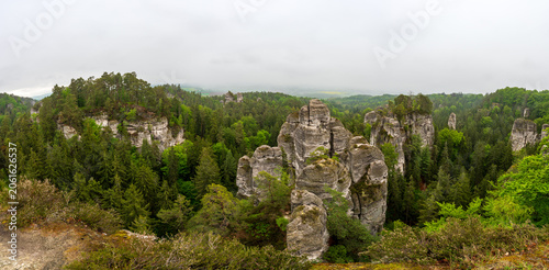 Rock city formations in Hruboskalsko, Bohemian Paradise (Cesky raj), Czech Republic, with peaks of giant sandstone rocks and cliffs emerging from light morning mist panoramic view