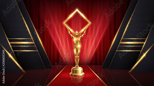 Golden trophy on red stage with dramatic spotlight in dark auditorium