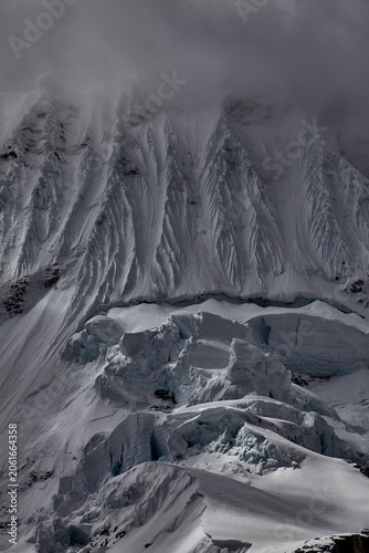the south face of Chacraraju, captured here in a brooding, steel-blue study of glacial architecture at its most merciless and magnificent, belongs unambiguously, irrevocably to the second category. 