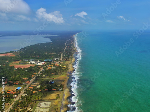 Aerial Drone View of Sri Lanka's Coastline – Turquoise Ocean, Lagoon and Palm-Lined Village