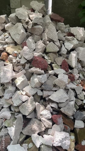 Pile of construction debris with broken bricks and concrete rubble
