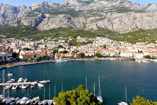 Makarska, Croatia. Coastal town, sea and mountains, Biokovo park. Aerial photography from a drone. Croatian town on the Adriatic Sea. Makarska Riviera