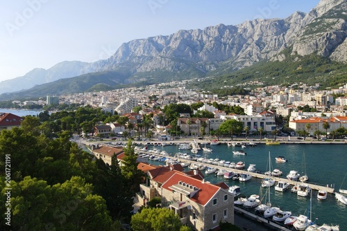 Makarska, Croatia. Coastal town, sea and mountains, Biokovo park. Aerial photography from a drone. Croatian town on the Adriatic Sea. Makarska Riviera