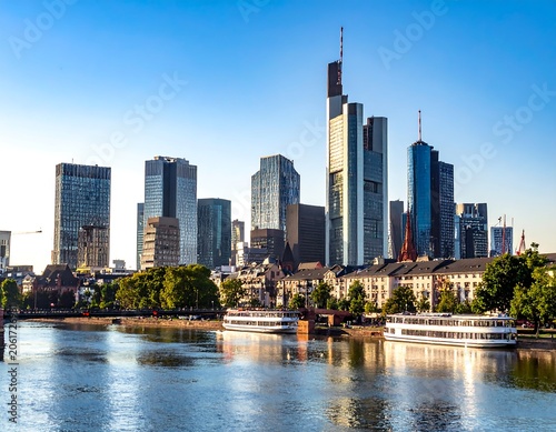 A serene cityscape with a river and modern skyscrapers