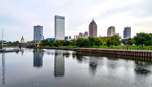 A serene cityscape with a river in the foreground