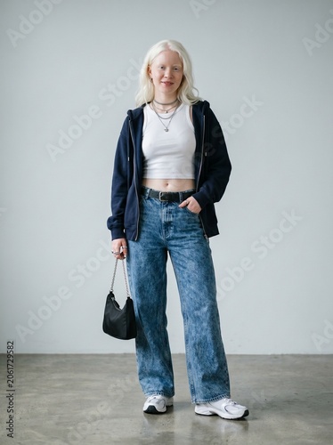 Young Albino Fashion Model Wearing Modern Y2K Outfit  Casual Streetwear Hoodie and Blue Jeans
