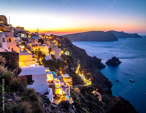A serene cliffside village at dusk, with white buildings and warm lights overlooking a vast calm sea